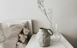 white ceramic vase on white book