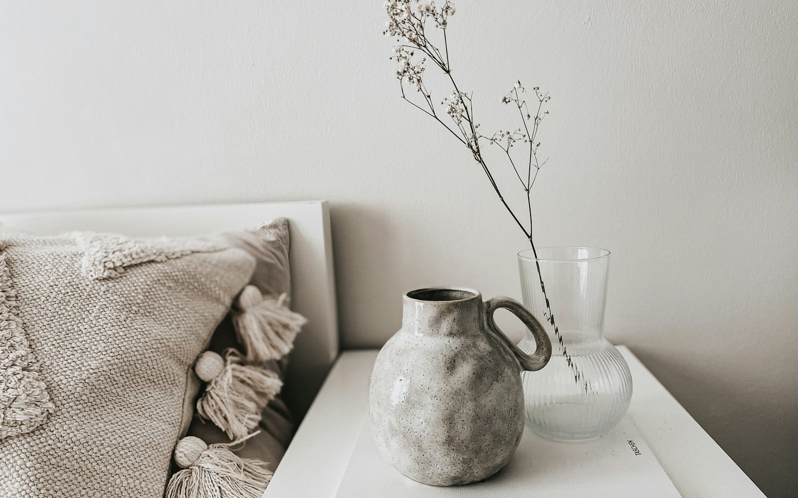 white ceramic vase on white book