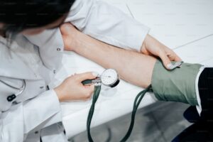 RN checking blood pressure of a patient during in-home alcohol detox monitoring
