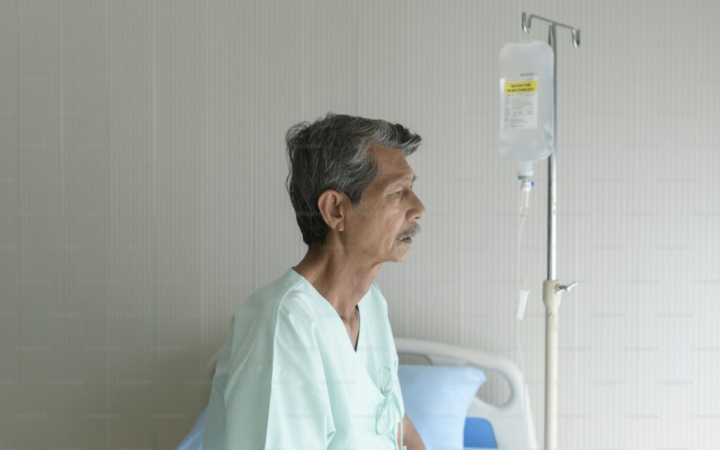 Portrait of senior patient lying on bed in hospital, healthcare and medical concept