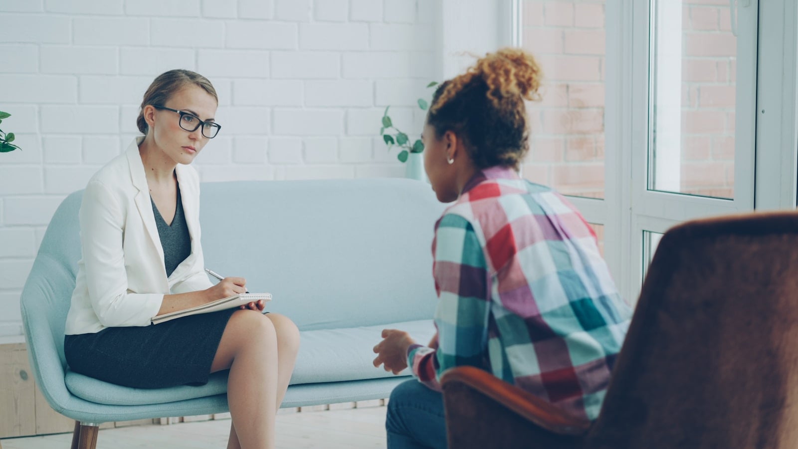 Therapist listening attentively to a client during an anxiety counseling session