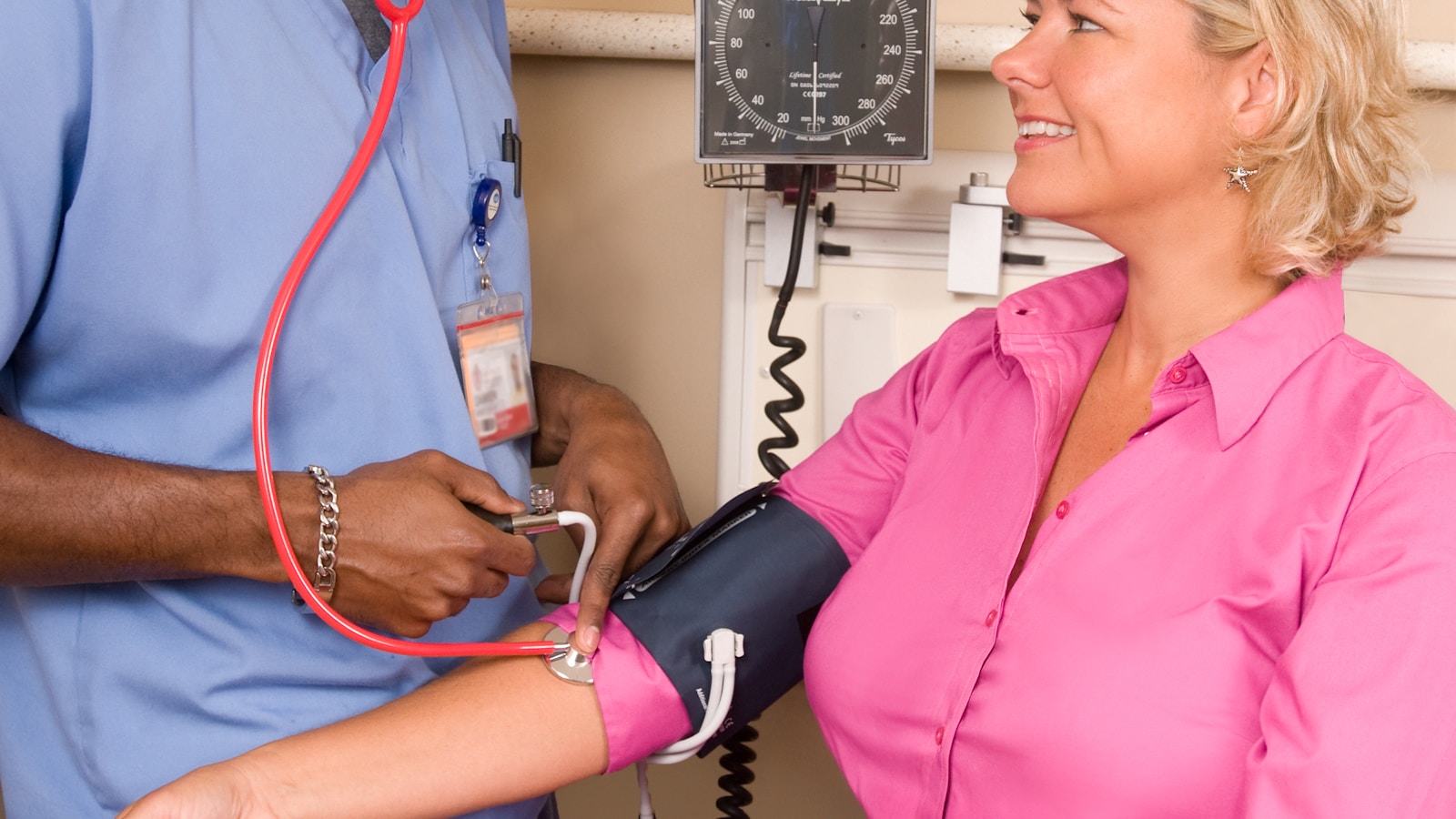 nurse checking a patient blood pressure during an in-home stimulant detox visit