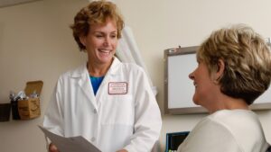 clinician reviewing medical screening criteria with a patient before in-home detox